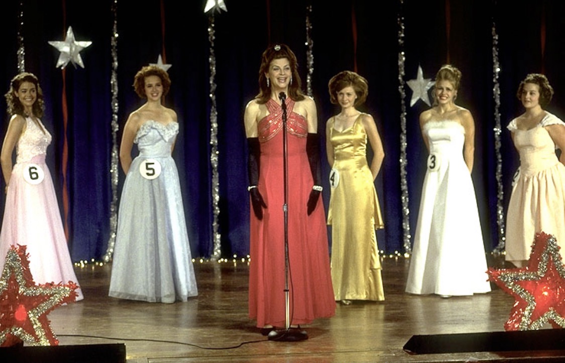 Drop Dead Gorgeous: a line of female pageant contestants in gowns onstage